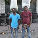 Many people try to muddle through as street vendors. The picture shows two boys selling drinking water in little bags.