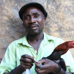 Man displaying his fighting-cock.